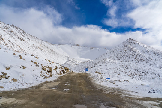 The road and mountain with snow coverage at Changla Pass in winter. This is the route to Pangong Lake from Leh. It is claimed to be the second highest motorable road in the world