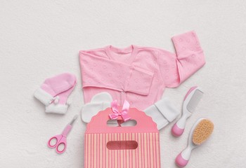 Set of clothes for the newborn and child care items.