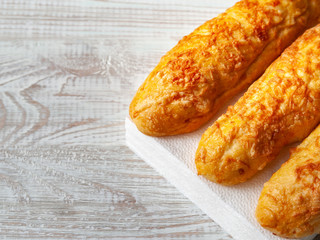Cheese buns, bread with cheese on a white wooden background. Copy space