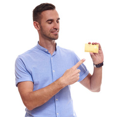 Happy smiling young man showing credit card isolated on white background