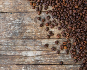 Coffee beans on old wood background