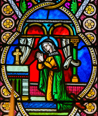 Fototapeta na wymiar Stained Glass in Monaco Cathedral - Mother Mary in Prayer
