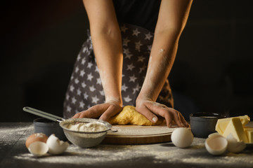 woman knead dough in the kitchen