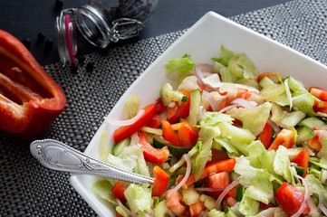 Healthy eating. Fresh vegetable salad in a white plate.