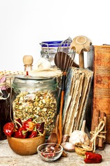 Kitchen utensils on a wooden table. White background. Food preparation. Cookbook and cooking ingredients. Old book