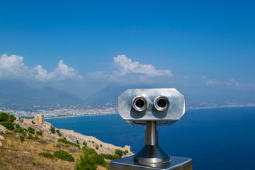 Binocular against the sea and sky. Observation of an ancient fortress.