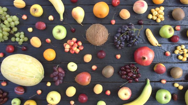 Fruits on black ecological background. Top view.

Various fruits are located on black wooden eco background. On eco table are: cherries, lemon, tangerines, peaches, pears, coconat