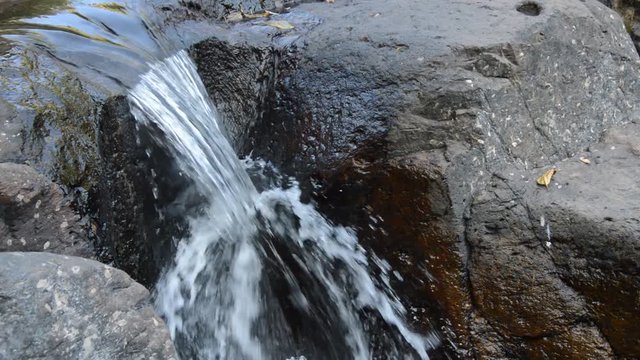 water falling on river pass rock and stone in forset