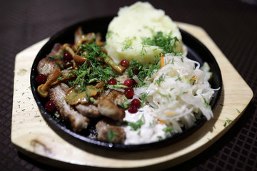 Meat with vegetables in skillet