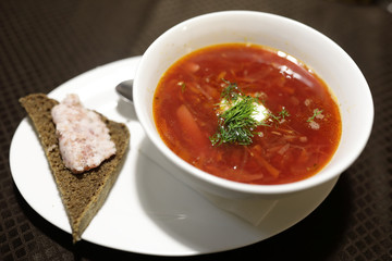 Plate of borsch with piece of bread