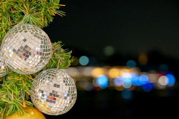 Glass ball ornaments on a Christmas tree and blurred lights. with clipping path.