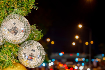 Glass ball ornaments on a Christmas tree and blurred lights. with clipping path.