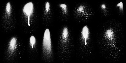 Realistic grunge graffiti spray paint effect on the black background. Isolated white ink texture.