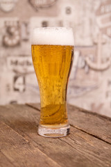 lager draft beer in a glass on dark wooden table
