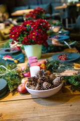 bumps, candles and flowers on Table with accessories for making by hand a unique magic Christmas wreath, background
