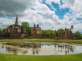 Fototapeta na wymiar Ruin of ancient Pagoda or stupa reflection in the water in Wat mahathat Temple Area At sukhothai historical park,Sukhothai city Thailand