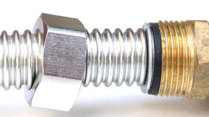 Fittings for pipe fastening. Threaded connection of stainless corrugated pipe, isolated photo on...