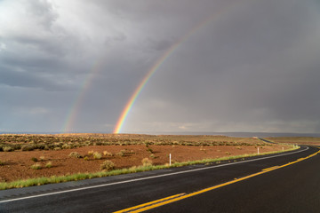 End of a rainbow on red rocks, south west America
