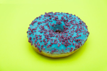 blue donut with sprinkles isolated on green background