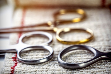 several suture scissors on bendaje in operating theater of a hospital, conceptual image
