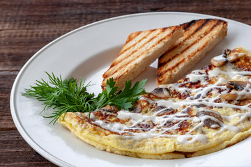 Vegetarian breakfast: scrambled eggs with mushrooms, greens and croutons on a white plate