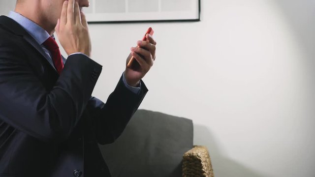 a man using his smartphone. looking through erotic content. he flirts talking on video