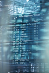 Flights information departures board in airport terminal.