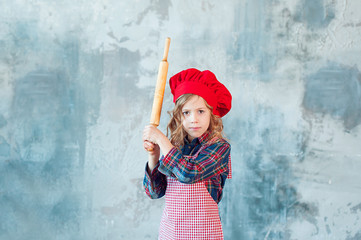 rolling pin in the hands of the cook