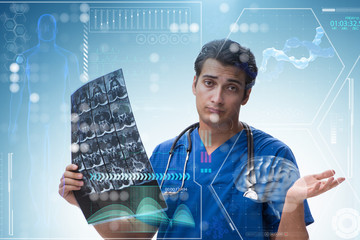 Young doctor looking at x-ray image in mhealth concept