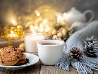 Chocolate chip cookies, cup of tea on dark christmas background. Cozy evening, mug of drink,...