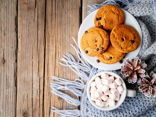 Chocolate chip cookies with cocoa, marshmallow. Cozy evening, cup of drink.