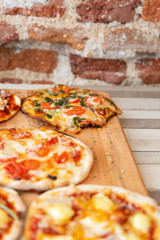 pizza on a wooden board on a wooden table