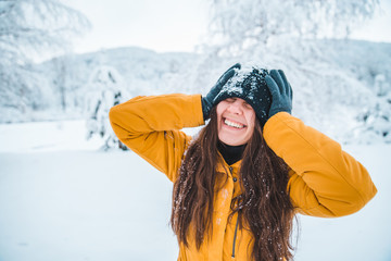 Fototapeta na wymiar smiling woman portrait outdoors snow on hat
