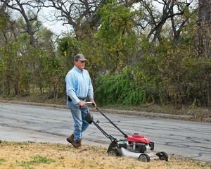 Man mowing front lawn