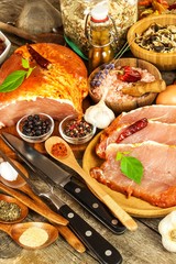 Pork chop on old wooden table. Raw meat and spices. Marinated pork meat on grill
