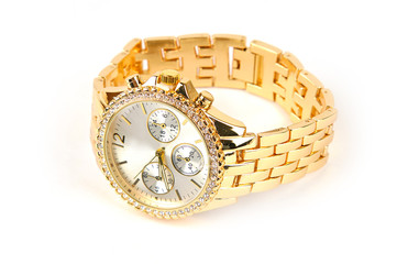 Wrist watch of golden color on a bracelet on a white isolated background.