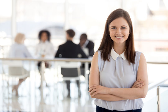 Millennial ambitious team leader, young employee, hr manager, female worker, intern girl smiling looking at camera, happy successful professional or business coach posing in modern office, portrait