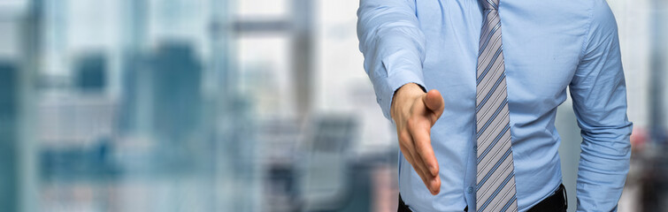 Young manager giving you a handshake