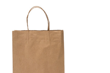 Ecological empty craft brown paper bag with handle isolated on white background. Closeup copy space.