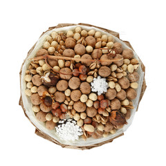 Decorative bouquet consisting of various nuts on a white background. Top view