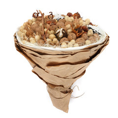 Decorative bouquet consisting of various nuts on a white background. Side view
