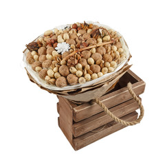 Decorative bouquet consisting of different nuts is in the wooden box on a white background