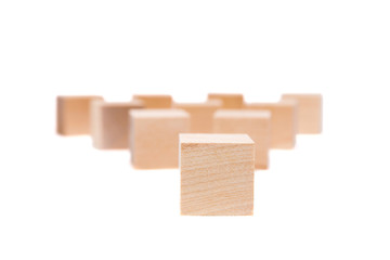 Obraz premium Light yellow wooden cubes on white background. Isolated on white. Business, finance, education