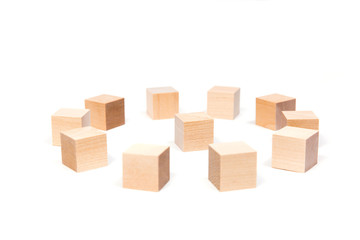 Light yellow wooden cubes on white background. Isolated on white. Business, finance, education