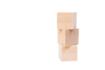 Light yellow wooden cubes on white background. Isolated on white. Business, finance, education