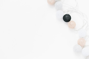 White, black, gold, silver christmas lights on white textured background.