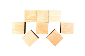 Light yellow wooden cubes on white background. Isolated on white. Business, finance, education