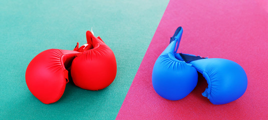 Red and blue karate gloves lies on the ring