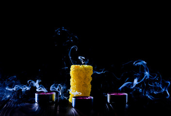 candle extinguished on black background