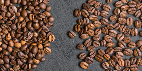coffee beans (good and bad grain) - arabica and robusta blend (roasted coffee grain). Black background. Top view . Copy space.
